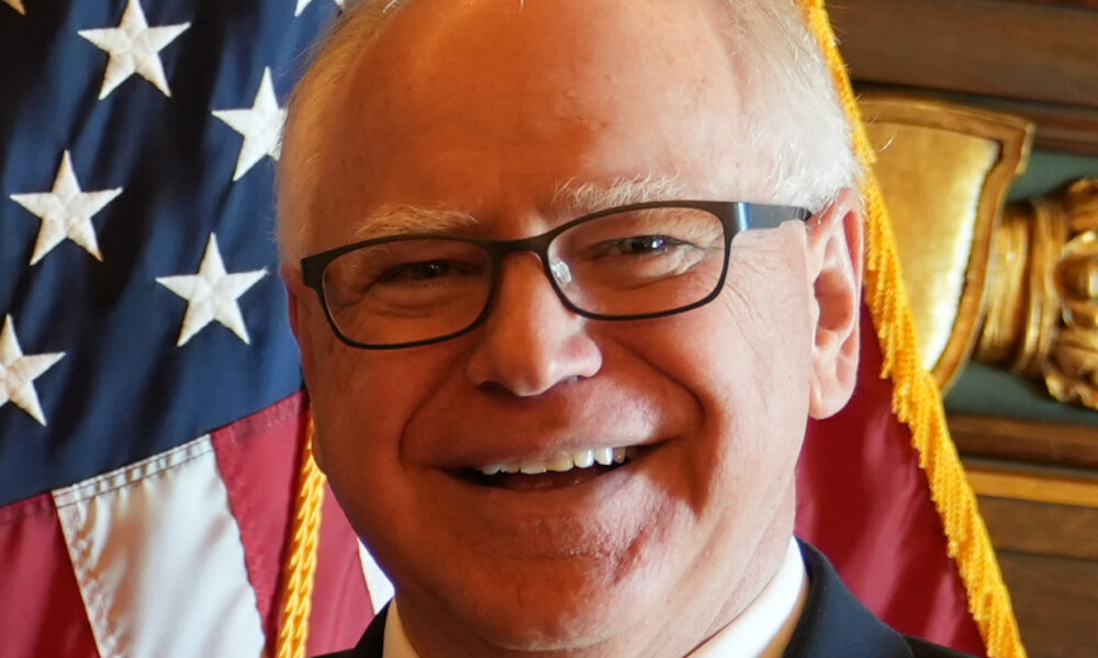 Governor Tim Walz of Minnesota close-up with USA flag behind him