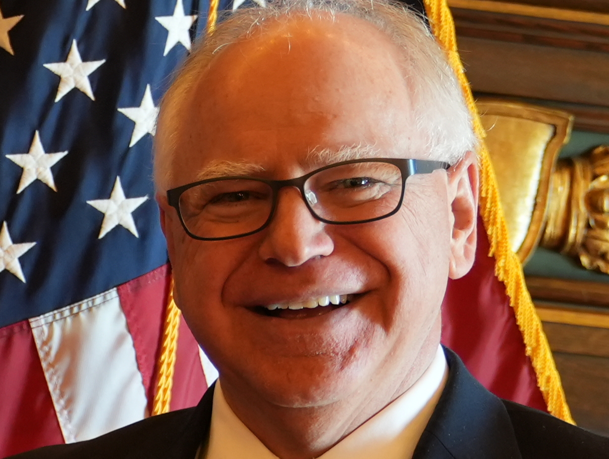 Governor Tim Walz of Minnesota close-up with USA flag behind him