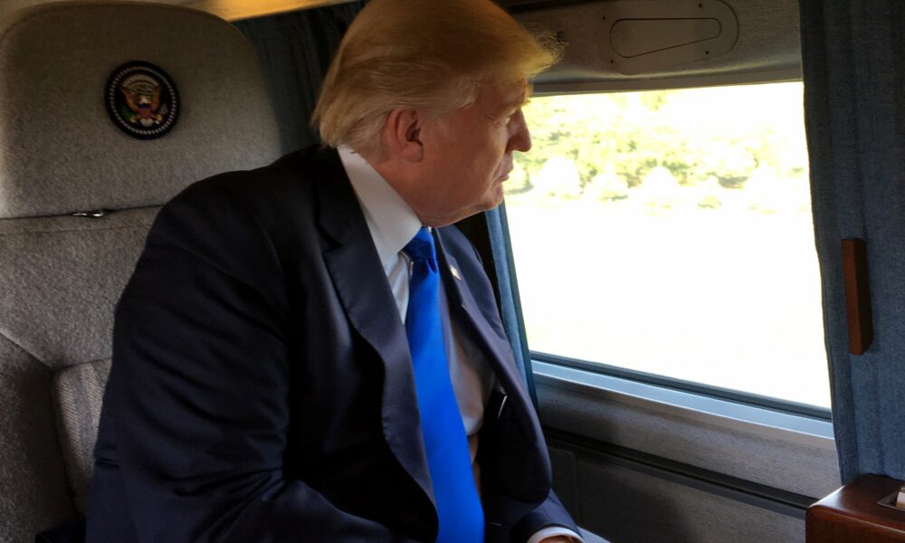 Donald Trump looking out the window of his aircraft