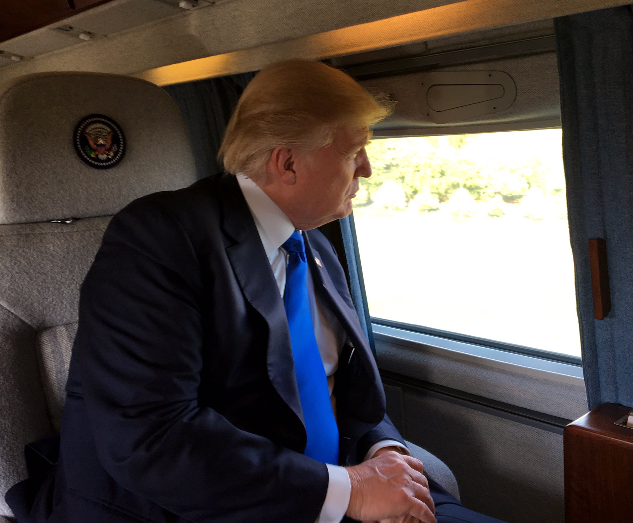 Donald Trump looking out the window of his aircraft