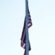 American flag hanging limp on poll in Arlington, Massachusetts