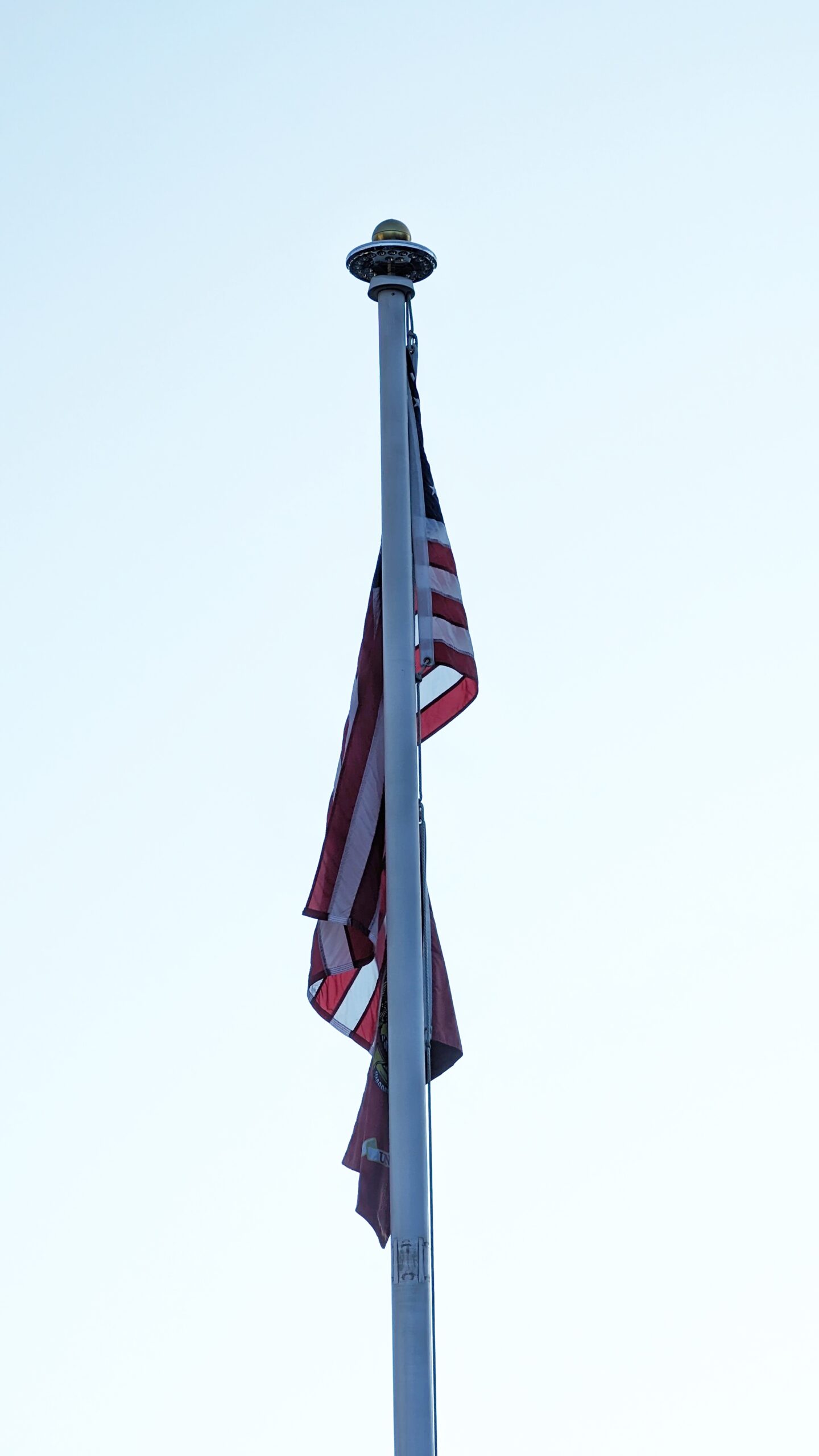 American flag hanging limp on poll in Arlington, Massachusetts