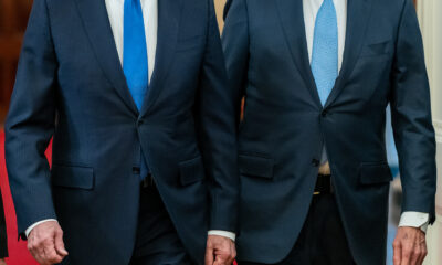 Presidents Joe Biden and Bill Clinton walking to the East Room with Vice-President Kamala Harris (not shown)