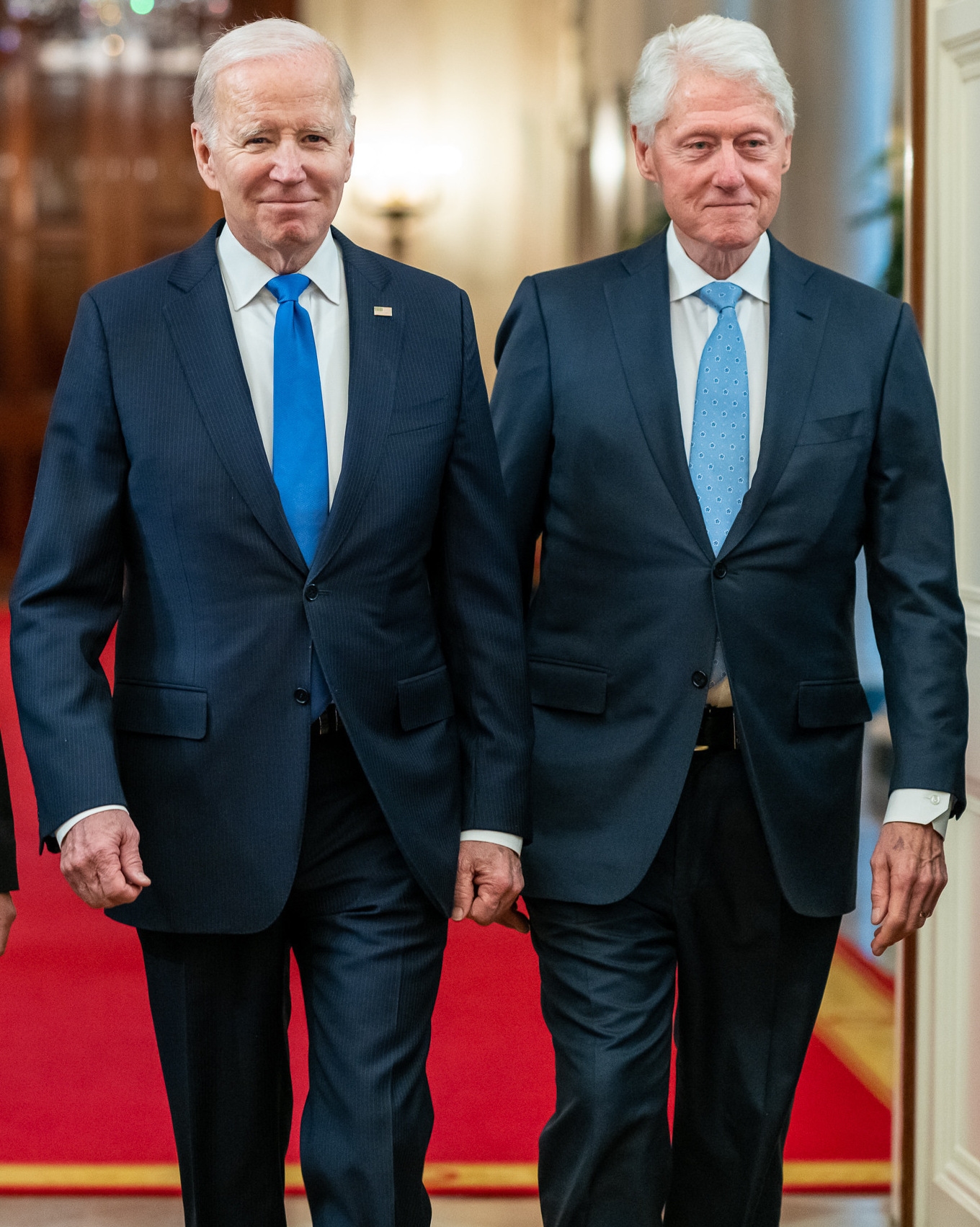 Presidents Joe Biden and Bill Clinton walking to the East Room with Vice-President Kamala Harris (not shown)