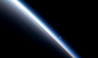 Earth from low orbit looking toward Moon on the night side of the terminator