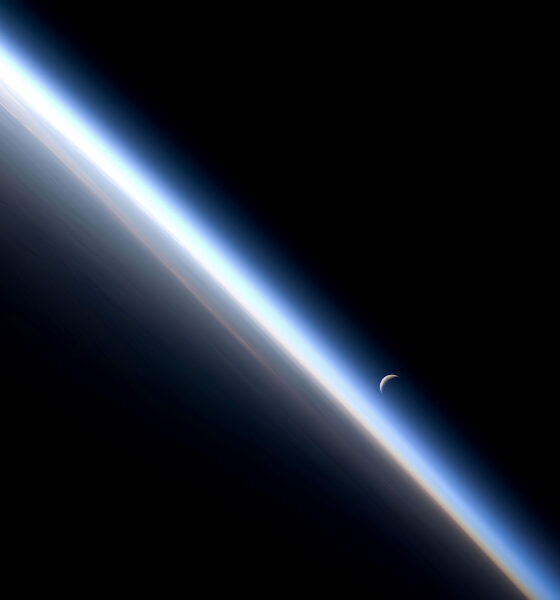 Earth from low orbit looking toward Moon on the night side of the terminator