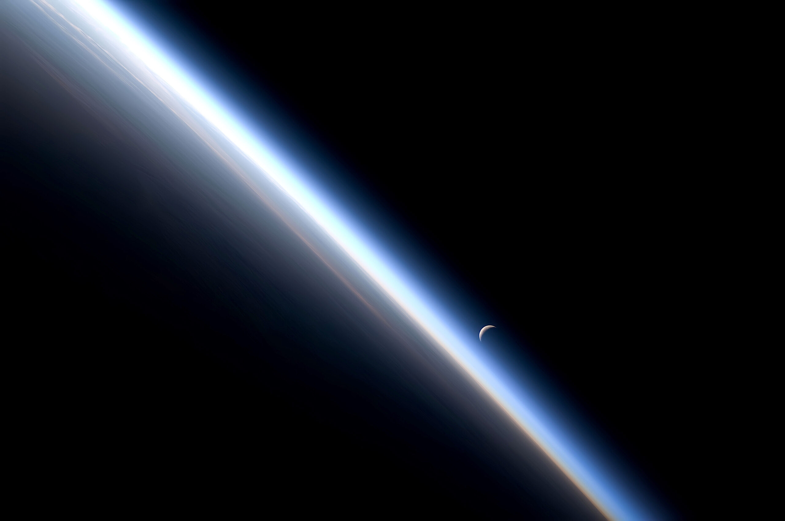 Earth from low orbit looking toward Moon on the night side of the terminator