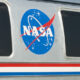 NASA meatball logo on an aircraft fuselage between two windows