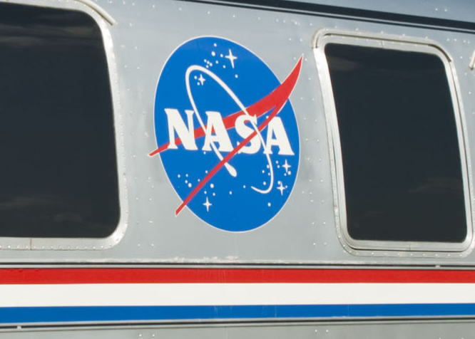 NASA meatball logo on an aircraft fuselage between two windows