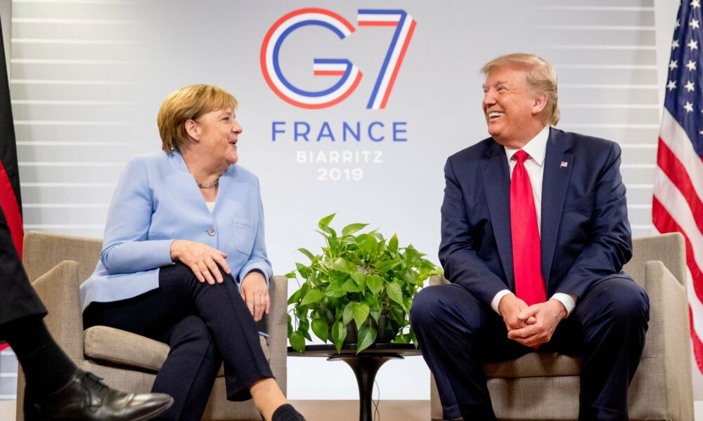 Donald Trump talks to German Chancellor Angela Merkel at the Biarritz G7 summit