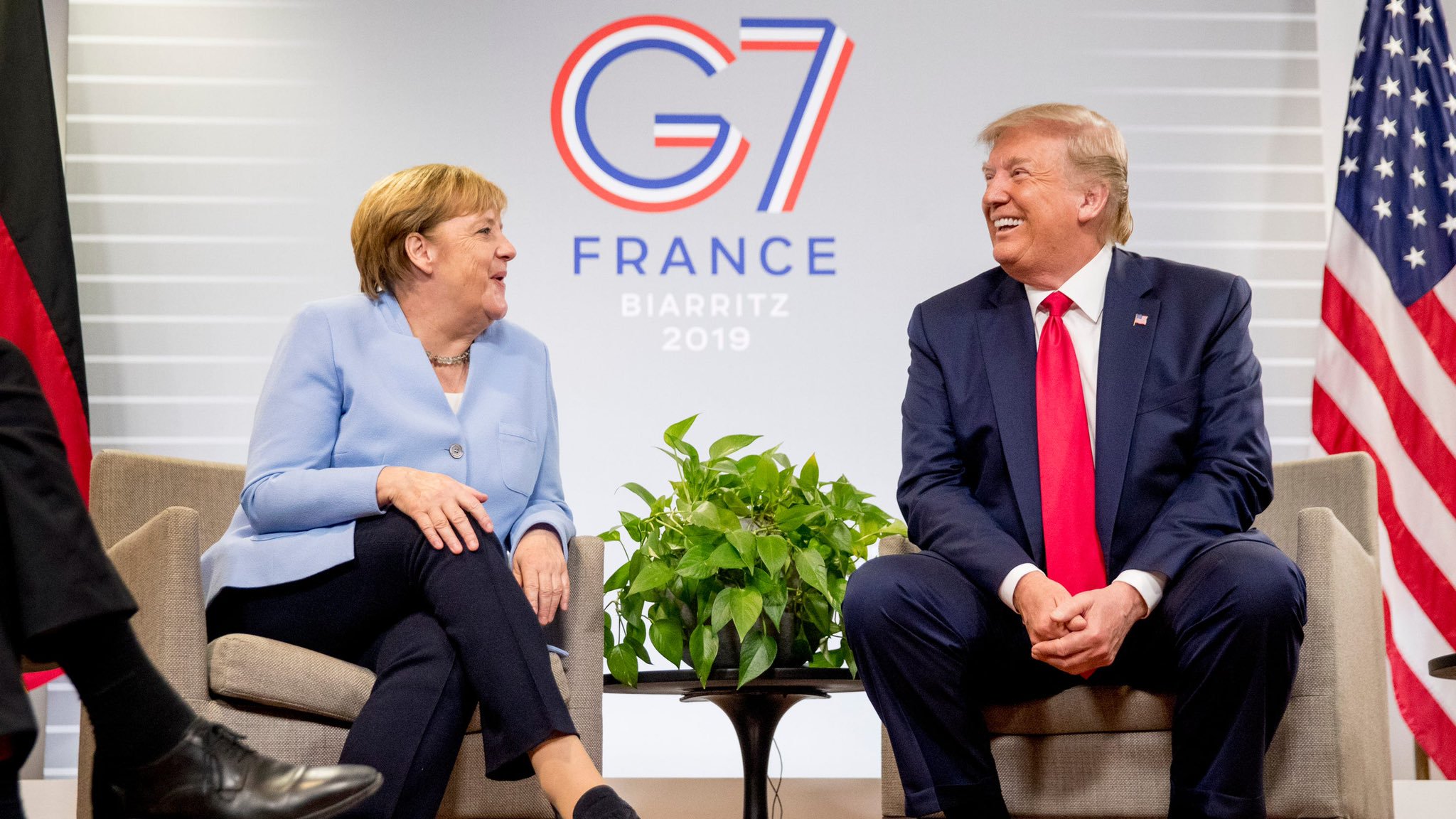 Donald Trump talks to German Chancellor Angela Merkel at the Biarritz G7 summit