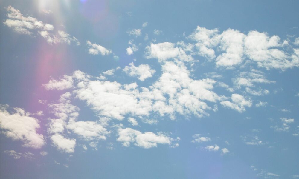 Cirrocumulus clouds with the sun creating a lens flare