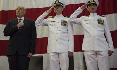 US SecHomeSec John Kelly, Captain William Huhm USN, and Lt Cmdr Charles Johnson USN aboard USS Kearsage LHD 3 at a change of command