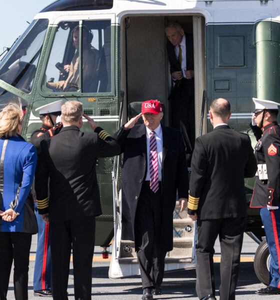 Donald Trump disembarks from Marine One and takes several salutes.