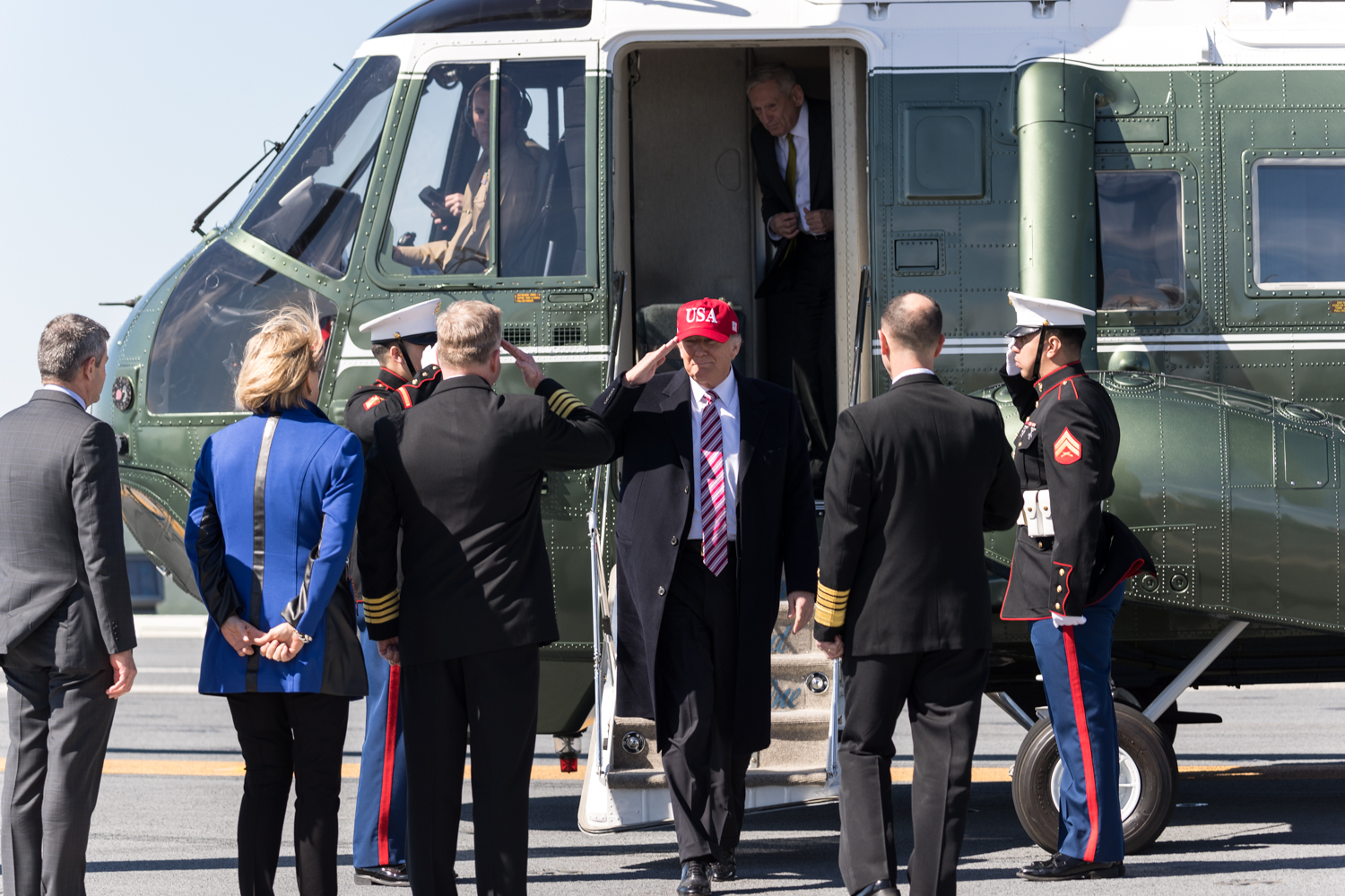 Donald Trump disembarks from Marine One and takes several salutes.