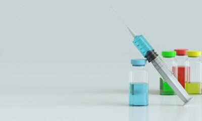 Syringe with needle and four bottles