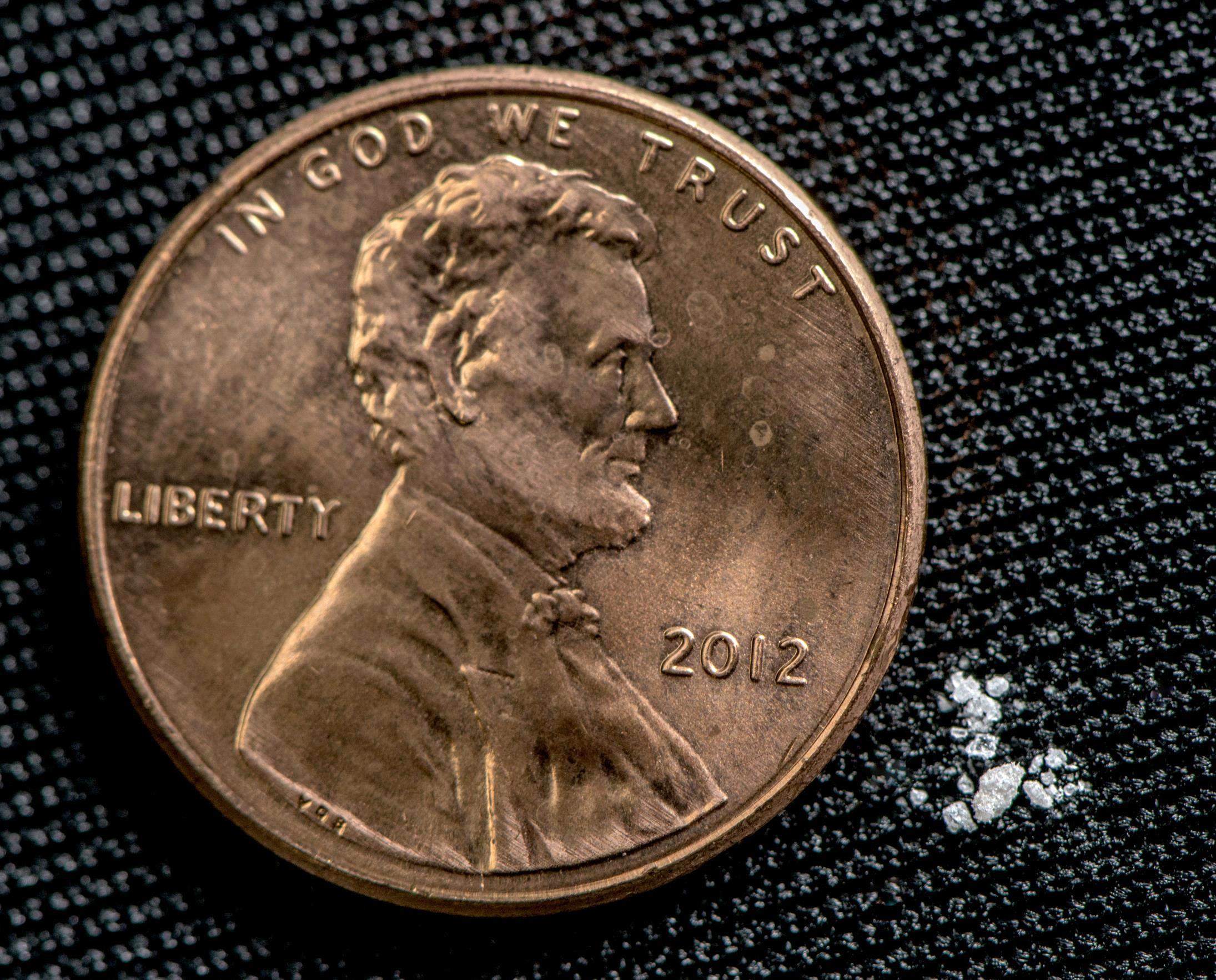 Fentanyl 2 mg next to a penny