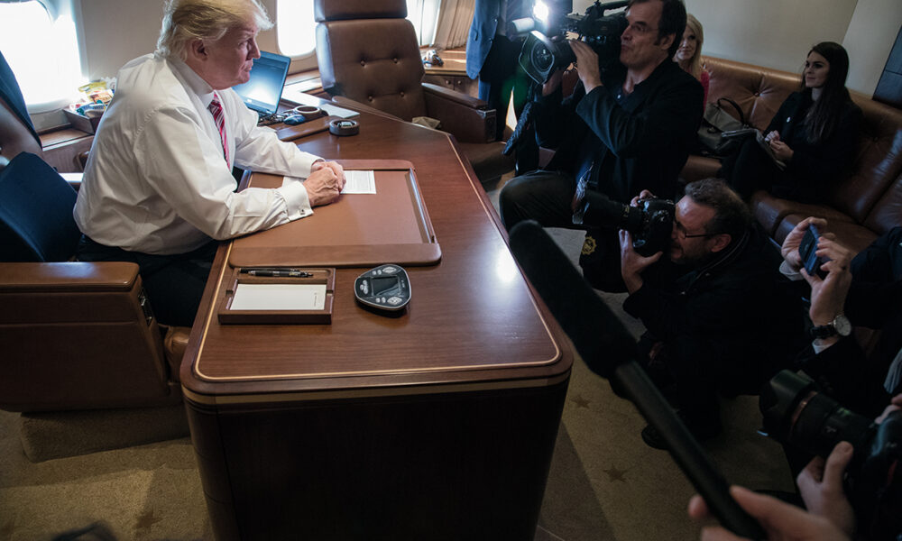 President Trump talks to reporters in his office aboard his special transport (call sign Air Force One) in flight from Philadelphia to Joint Base Andrews near Upper Marlboro, Maryland, 26 January 2017