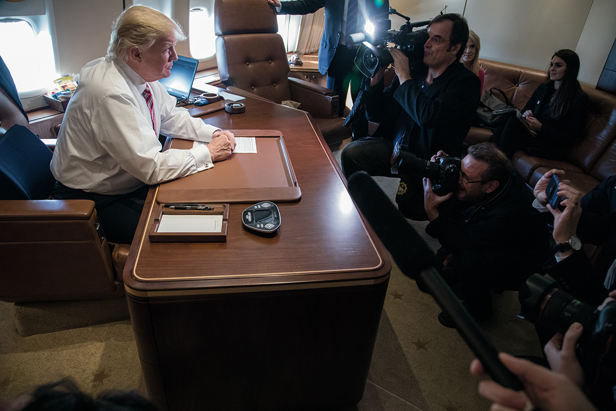 President Trump talks to reporters in his office aboard his special transport (call sign Air Force One) in flight from Philadelphia to Joint Base Andrews near Upper Marlboro, Maryland, 26 January 2017