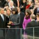 Barack Obama takes the oath of office - on a Koran - as his wife (?) and daughters (?) look on