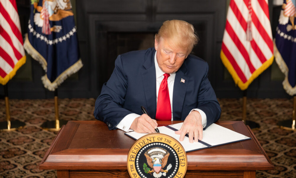 Donald Trump signs an Executive Order imposing sanctions on Iran on 5 August 2018