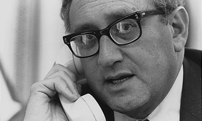 Henry Kissinger takes a telephone call