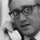 Henry Kissinger takes a telephone call