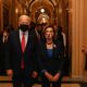 Joe Biden and Nancy Pelosi walk down a corridor - and everyone is masked up in fear of the dreaded coronavirus, putative cause of COVID