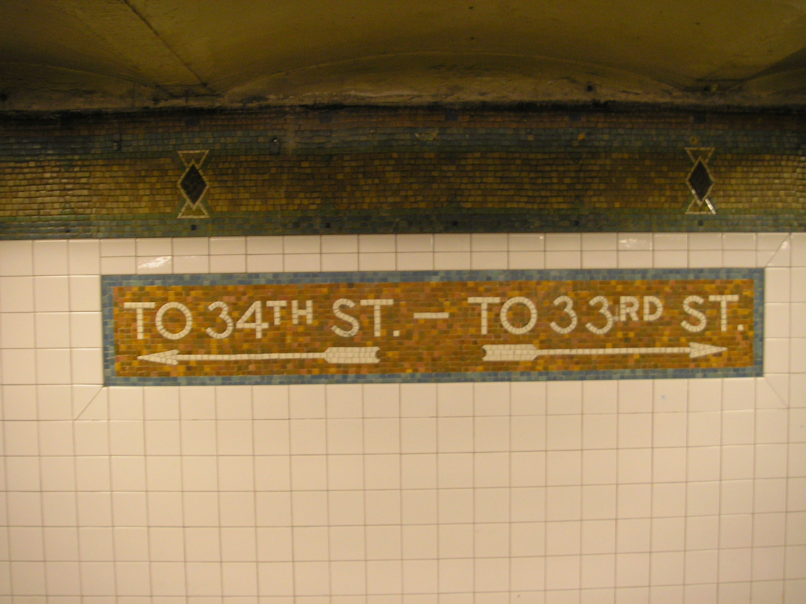 Tiled street exit markers in the New York City subway tunnel at its Pennsylvania Station stop