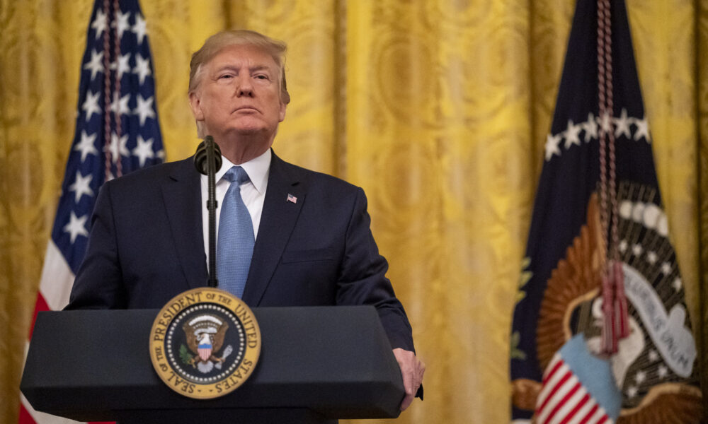 President Donald Trump frontal portrait with gold backdrop