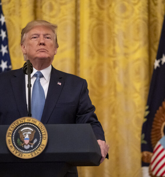 President Donald Trump frontal portrait with gold backdrop