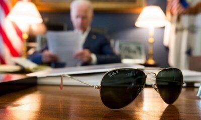 Vice-President Joe Biden at his desk, with his aviator sunglasses in the foreground.