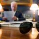 Vice-President Joe Biden at his desk, with his aviator sunglasses in the foreground.