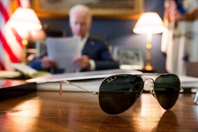 Vice-President Joe Biden at his desk, with his aviator sunglasses in the foreground.