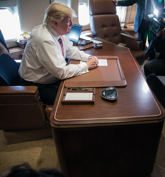 President Trump observes his first 100 days at his desk aboard his VC-25 ("Air Force One") transport.