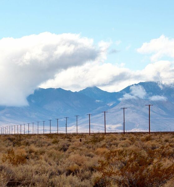 Powerlines with mountain ridge as backdrop