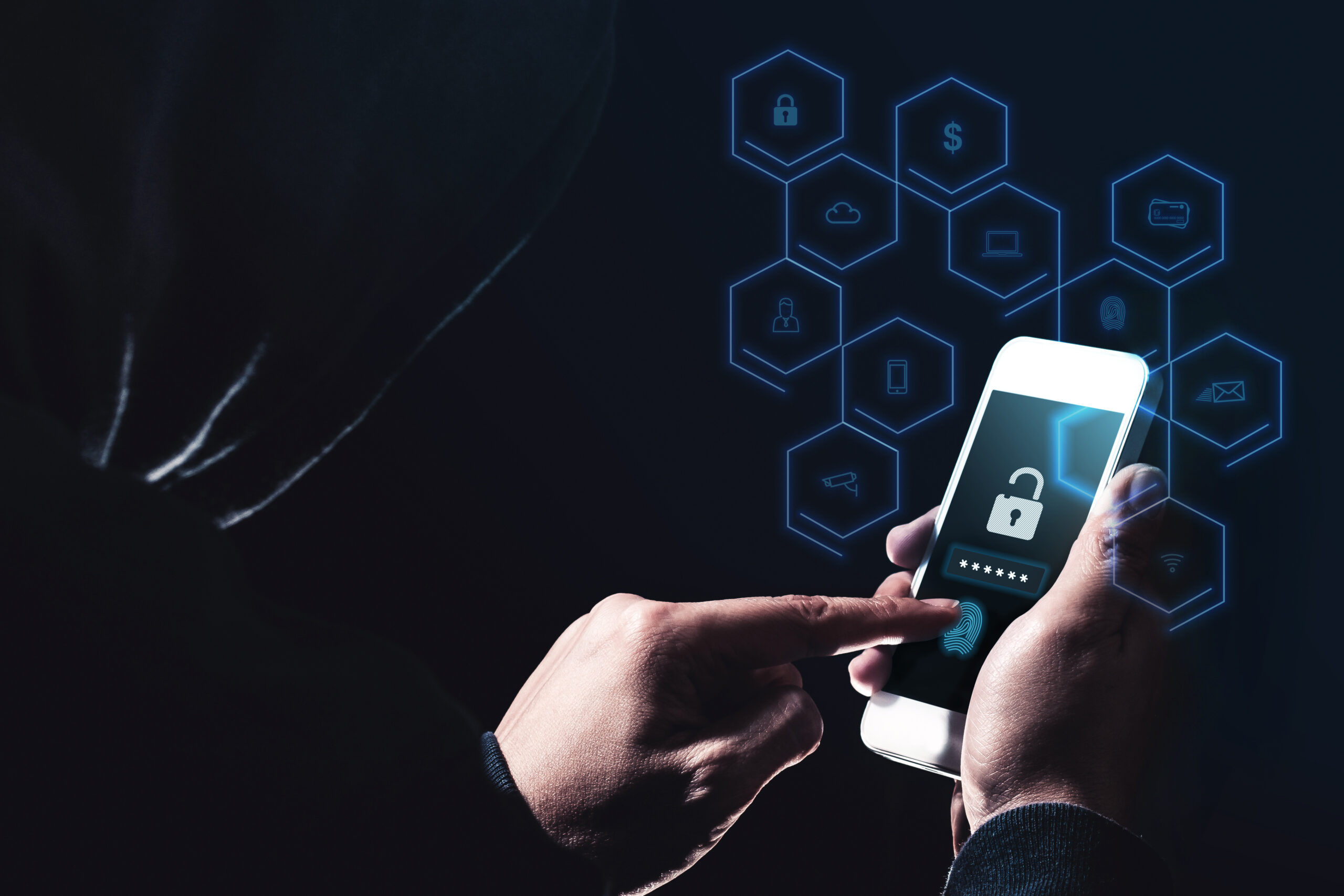 A cyber crime hacker uses a mobile phone to perpetrate another hack