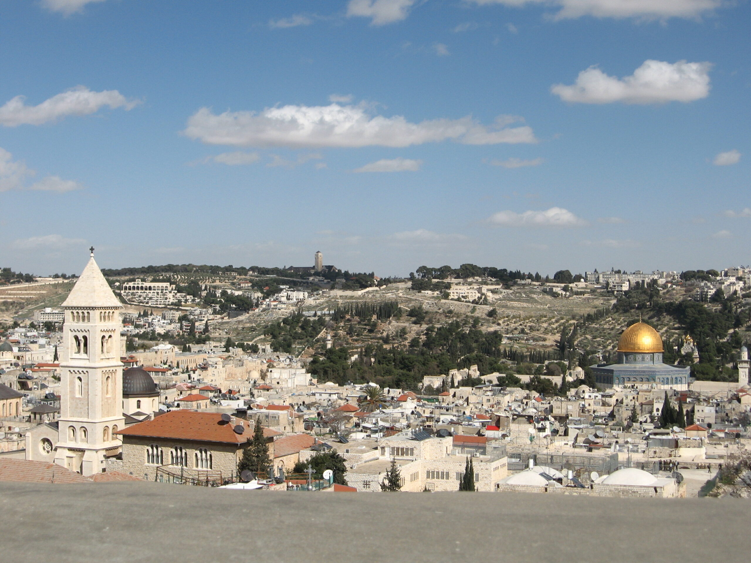 View of the Old City of Jerusalem, looking past the Temple Mount, toward the Church of the Ascension in the distance, from Mount Olivet. The Church of the Redeemer stands nearby and to the left.
