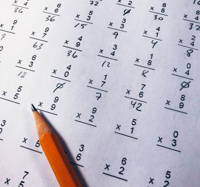 Brown pencil on paper with elementary single-digit multiplication exercises