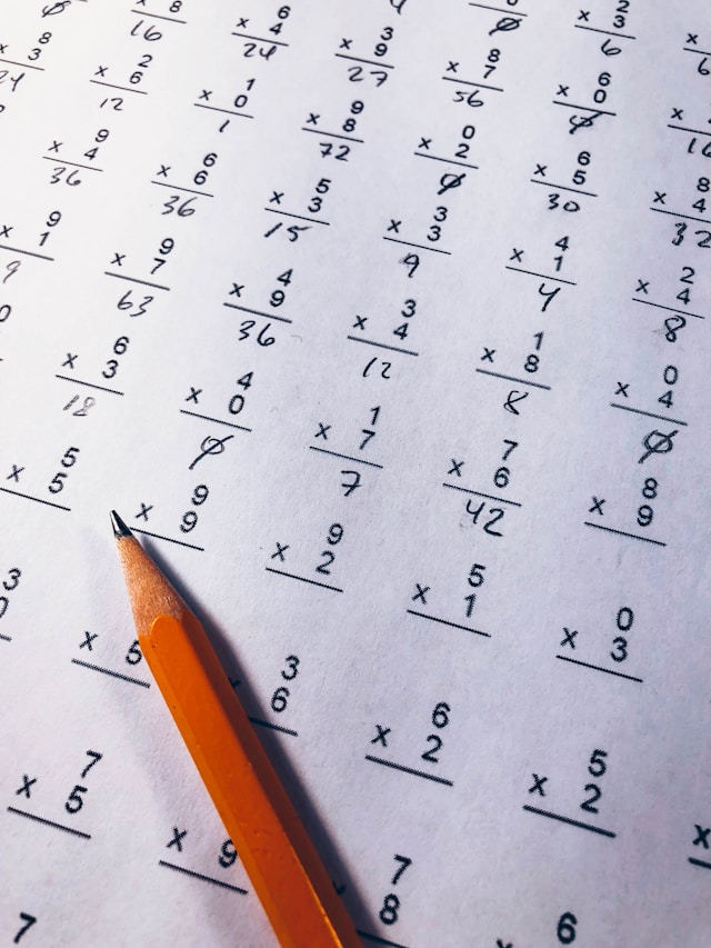 Brown pencil on paper with elementary single-digit multiplication exercises