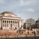 Columbia University library, oblique front-right elevation, with students congregating in small groups on the steps.
