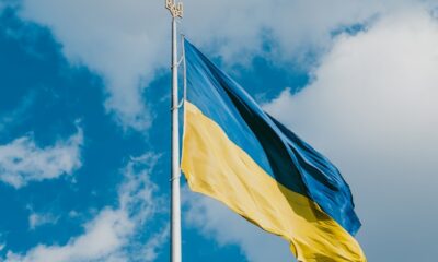 Flag of Ukraine on a flagpole with the Ukrainian raven on top