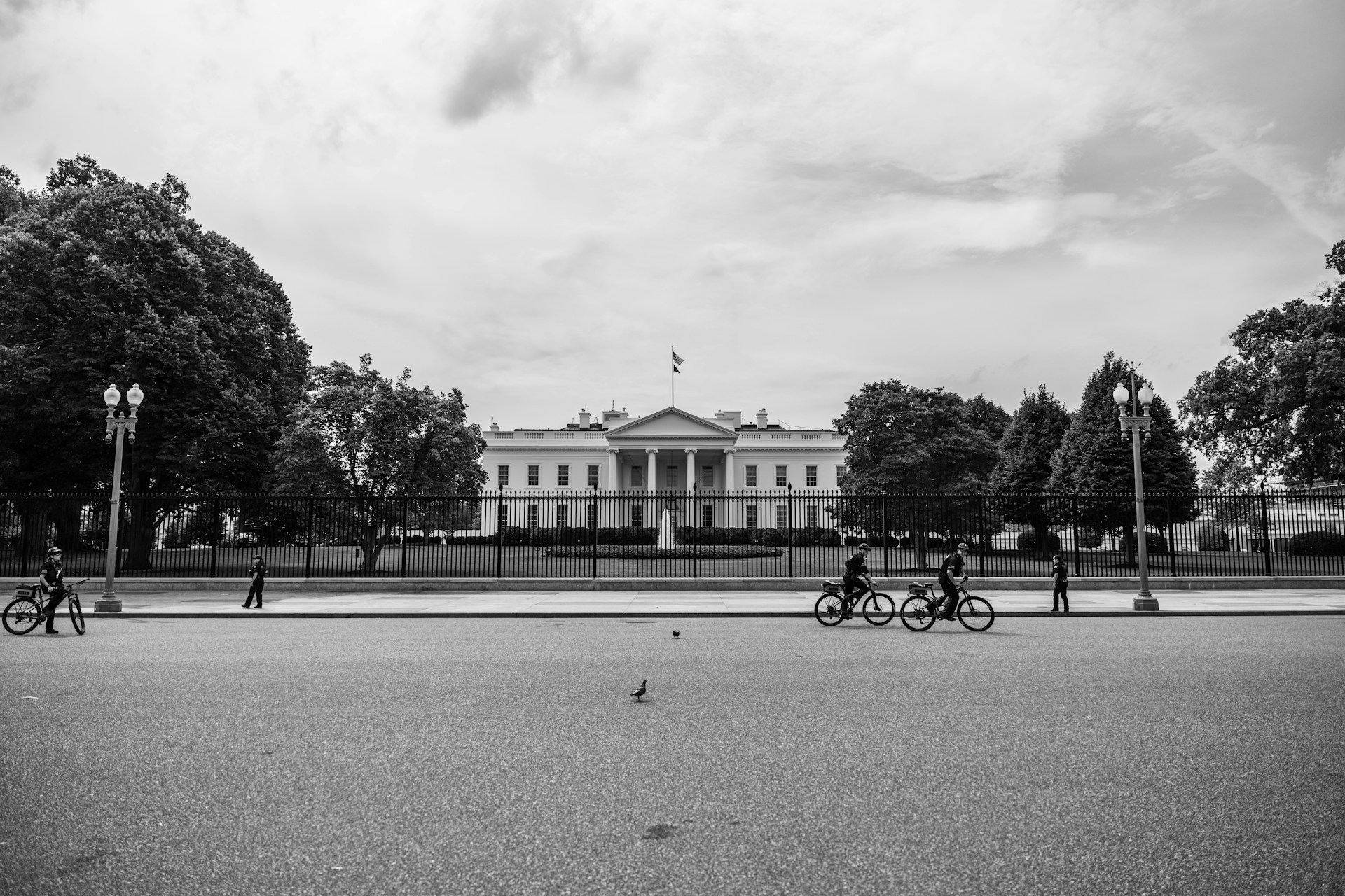 The White House, with bicyclists appearing before it