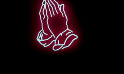 Praying hands in neon-like image