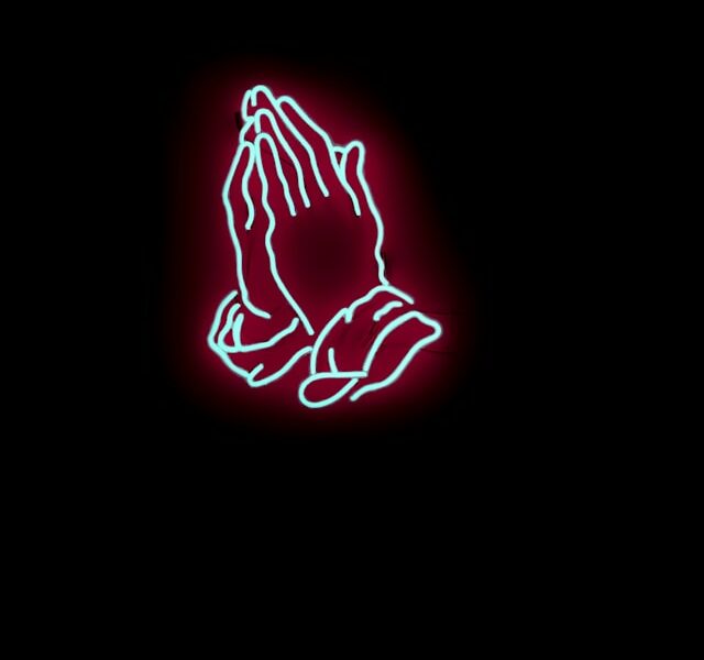 Praying hands in neon-like image