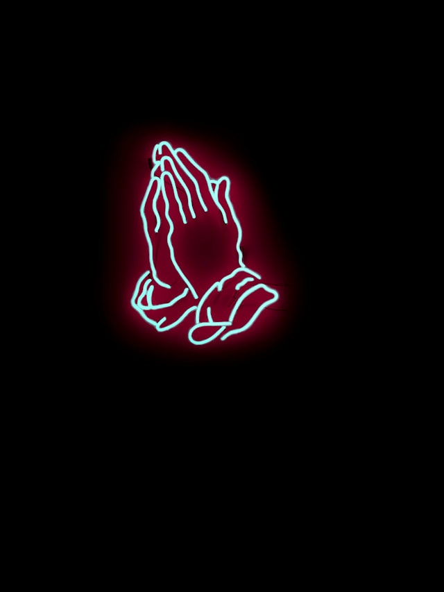 Praying hands in neon-like image