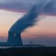 The cooling towers of a nuclear power plant, venting steam into the sunset - photo courtesy Frédéric Paulussen