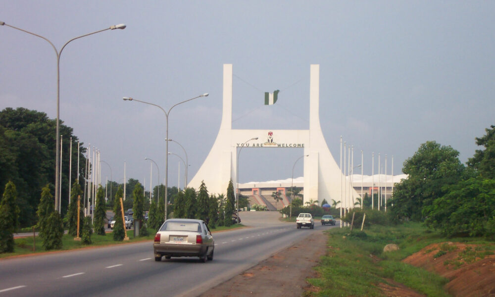 Main gate into Abuja, capital of Nigeria (note the English welcoming message).