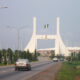Main gate into Abuja, capital of Nigeria (note the English welcoming message).