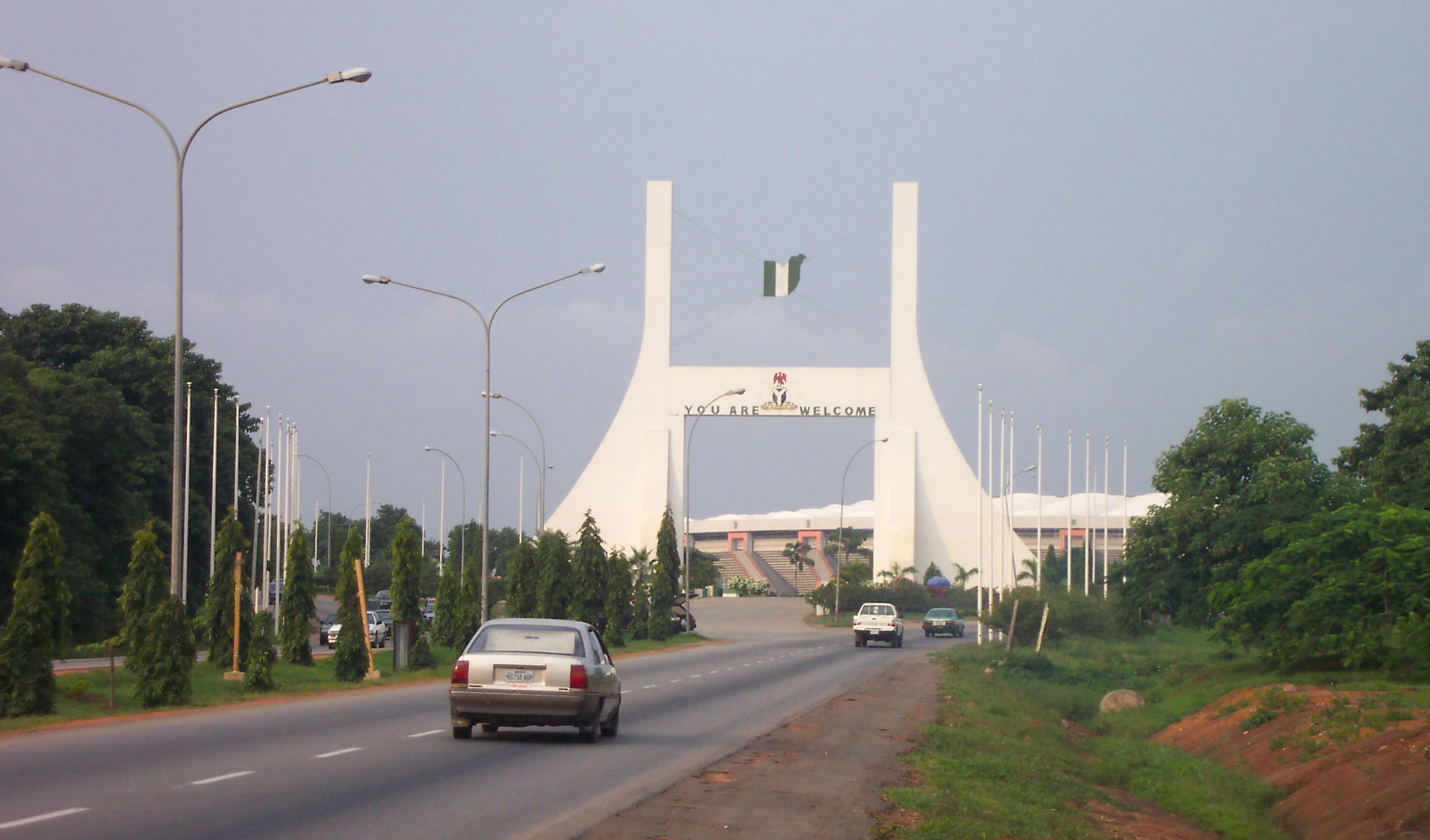 Main gate into Abuja, capital of Nigeria (note the English welcoming message).